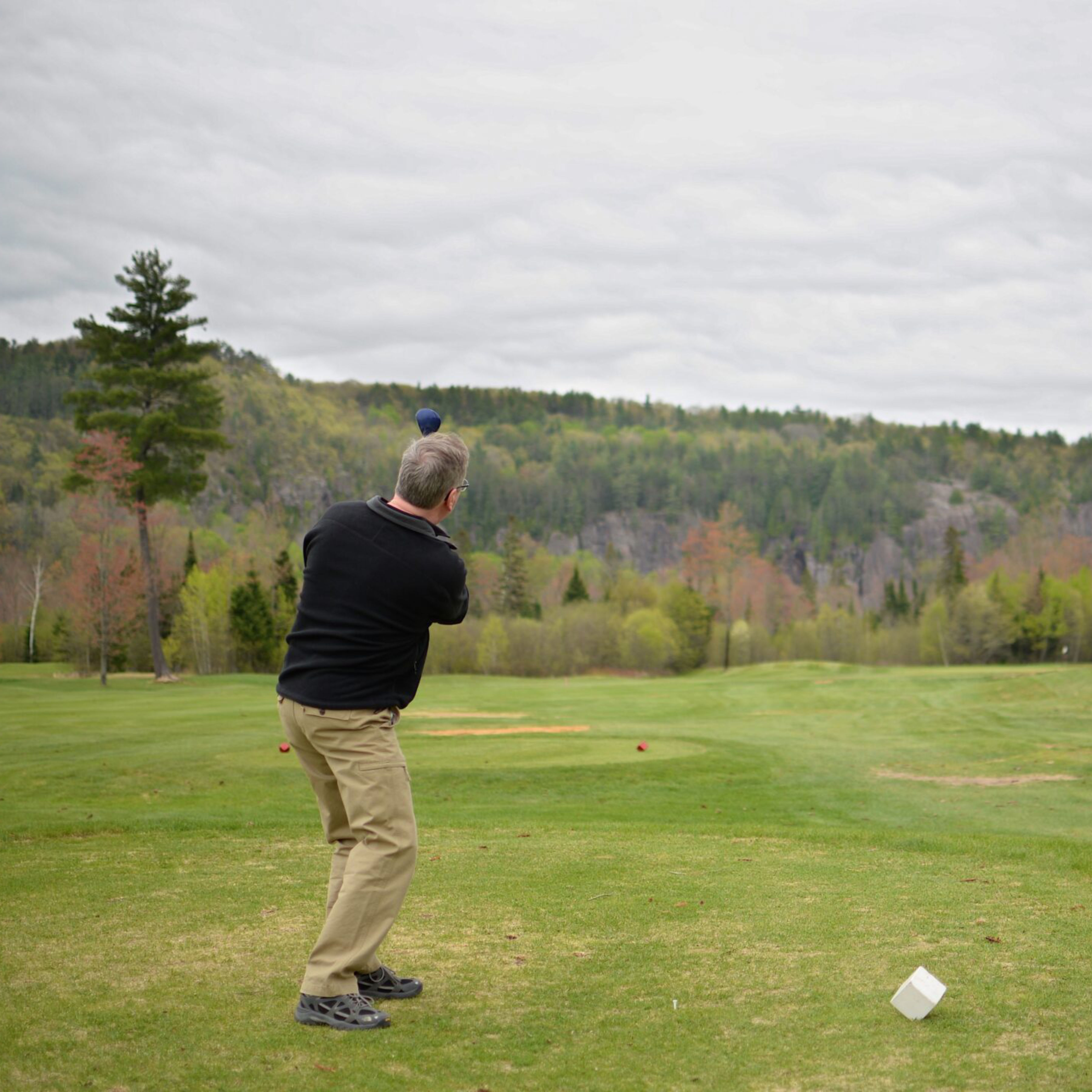 Person swinging a golf club
