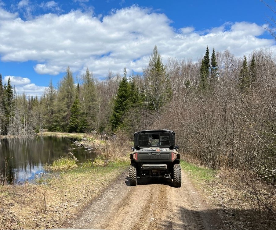 Utility Terrain Vehicle on a trail during a sunny day