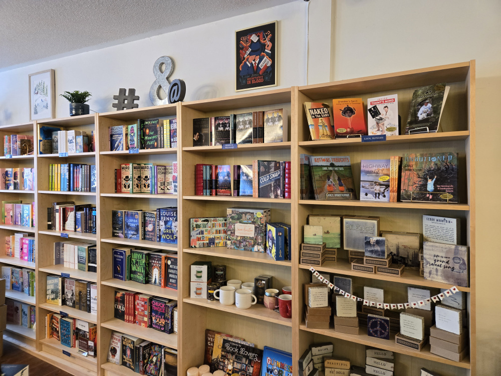 A row of bookshelves with books neatly organized in a bookstore.